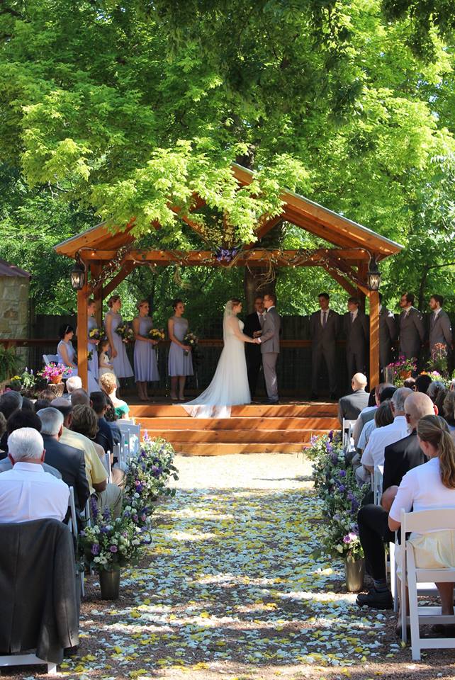 Wedding couple reading vows in a outdoor setting.