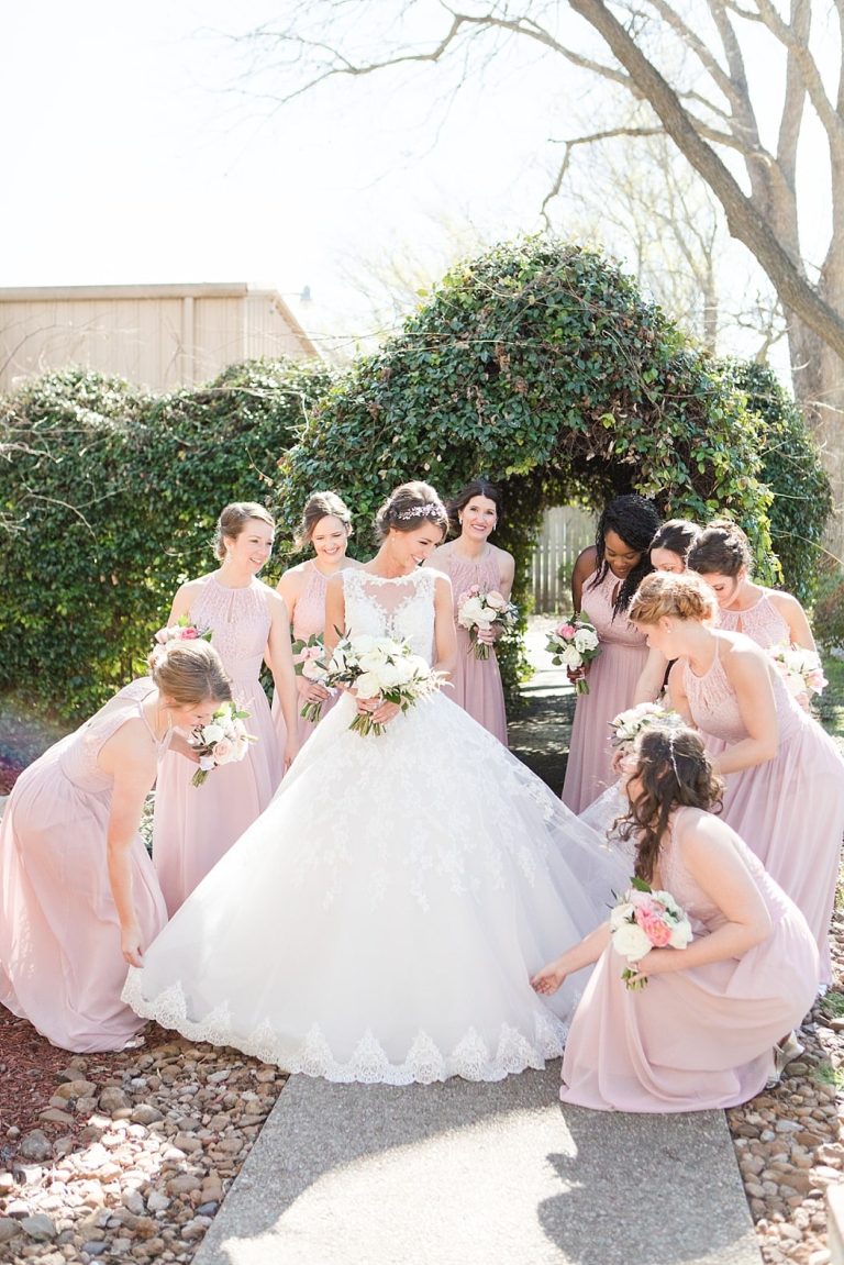 Bride surrounded by her bridesmaids in stunning outdoor wedding venue in Comfort
